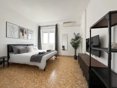 a bedroom with a bed and a television in it at Horizon - Concept Apartment in Rome
