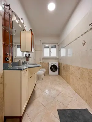 a bathroom with a sink and a washing machine at Horizon - Concept Apartment in Rome
