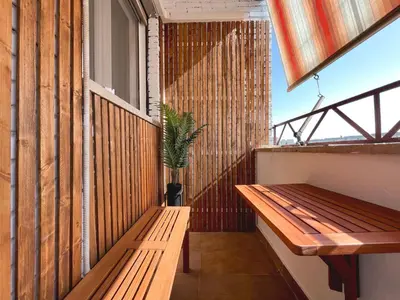a balcony with a wooden bench and a plant at Horizon - Concept Apartment in Rome