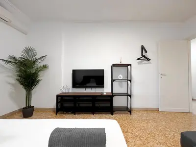 a living room with a tv on a white wall at Horizon - Concept Apartment in Rome
