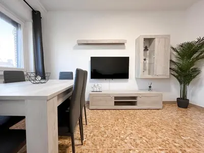 a dining room with a table and a tv in a room at Horizon - Concept Apartment in Rome