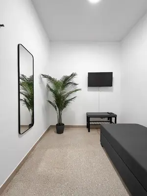 a living room with a black bed and a mirror at Horizon - Concept Apartment in Rome