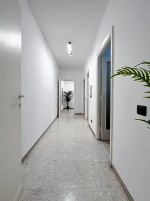 a hallway with white walls and a tile floor at Horizon - Concept Apartment in Rome