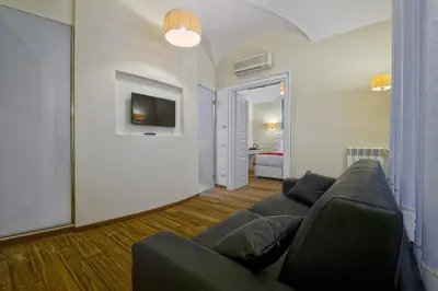 a living room with a couch and a tv at Star Vatican Rooms in Rome