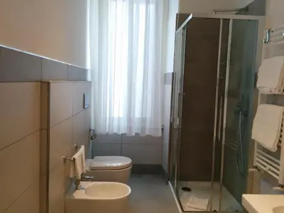 a bathroom with a shower and a toilet and a sink at Star Vatican Rooms in Rome
