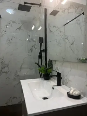 a bathroom with a white sink and a mirror at Candelor House - Apartment & Garden in Gianicolense in Rome