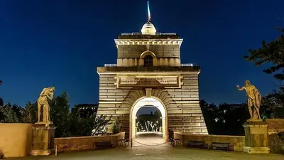 a building with an arch with statues on it at DOLCEVITA PONTE MILVIO in Rome