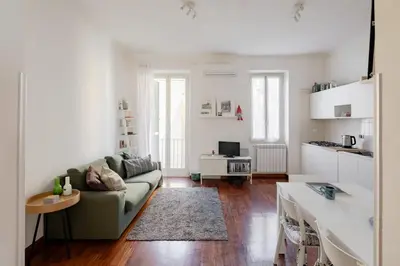 a living room with a couch and a kitchen at Domus Alberone in Rome