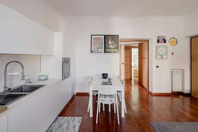 a kitchen with a white table and a sink at Domus Alberone in Rome