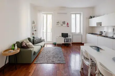 a living room with a couch and a kitchen at Domus Alberone in Rome