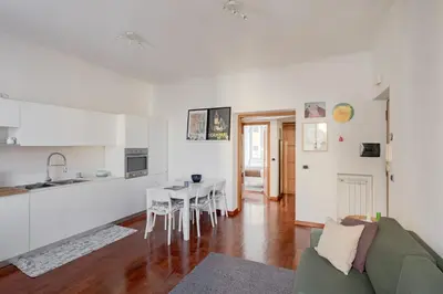 a kitchen and living room with a table and a couch at Domus Alberone in Rome