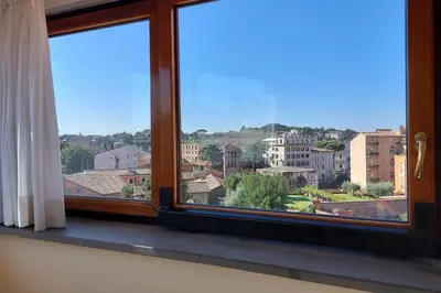 a window with a view of a city at Rooftop SUITE - FORO ROMANO LUX in Rome