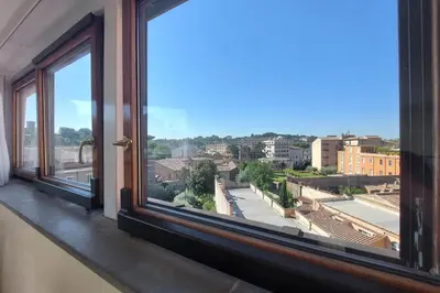 a window with a view of a city at Rooftop SUITE - FORO ROMANO LUX in Rome