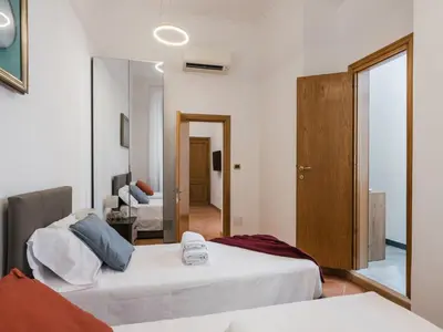 a bedroom with two beds and a mirror at The Best Rent - Three-bedroom apartment near the Quirinale in Rome