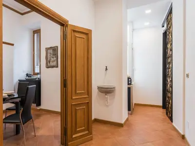 a bathroom with a door and a toilet in a room at The Best Rent - Three-bedroom apartment near the Quirinale in Rome