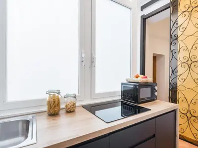 a kitchen with a counter top with a microwave at The Best Rent - Three-bedroom apartment near the Quirinale in Rome