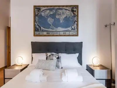 a bedroom with a large bed with two lamps at The Best Rent - Three-bedroom apartment near the Quirinale in Rome