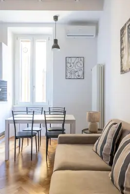 a living room with a couch and a table and chairs at Charming Vatican Apartment in Rome