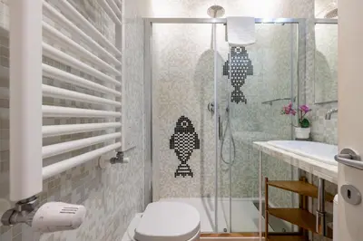 a bathroom with a shower and a toilet and a sink at Charming Vatican Apartment in Rome