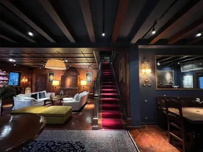 a lobby with a staircase and a living room at CHALET MARMONT ROME in Rome