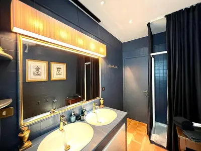 a bathroom with two sinks and a large mirror at CHALET MARMONT ROME in Rome