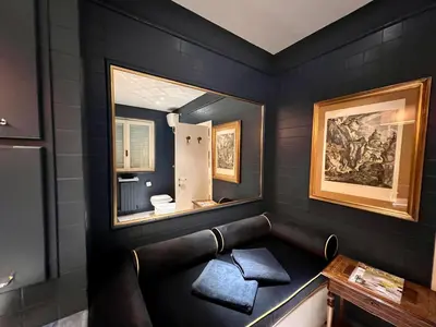 a black bathroom with a mirror and a sink at CHALET MARMONT ROME in Rome