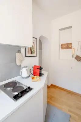a kitchen with a stove and a white counter top at Domus Paolina in Rome