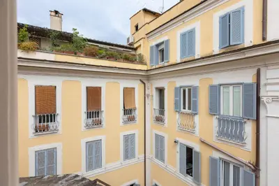 a yellow building with windows and balconies at Amazing Fontana di Trevi in Rome