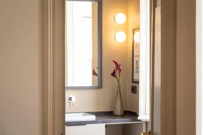a bathroom with a vase with a flower on a counter at Amazing Fontana di Trevi in Rome
