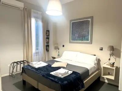 a bedroom with a bed with two towels on it at Le Due Civette Roma in Rome