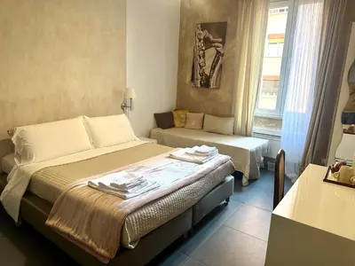 a small room with two beds and a couch at Le Due Civette Roma in Rome