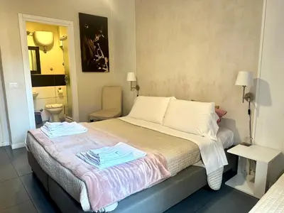 a bedroom with a bed with two towels on it at Le Due Civette Roma in Rome