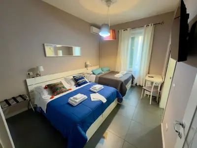 a bedroom with two beds with blue sheets at Le Due Civette Roma in Rome