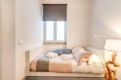 a bedroom with a bed with two towels on it at Trastevere 2 bdr orto botanico with private patio in Rome