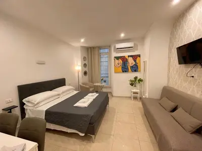 a bedroom with a large bed and a couch at The Room 15 in Rome