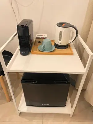 a white table with a coffee maker and a tea kettle at The Room 15 in Rome