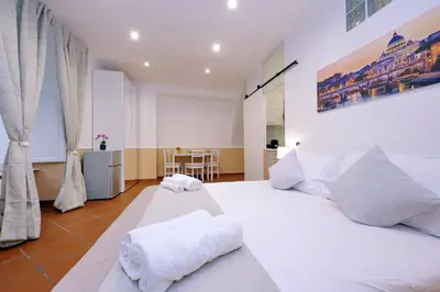 a bedroom with a large white bed with white pillows at Trevi Feddy's Apartment in Rome