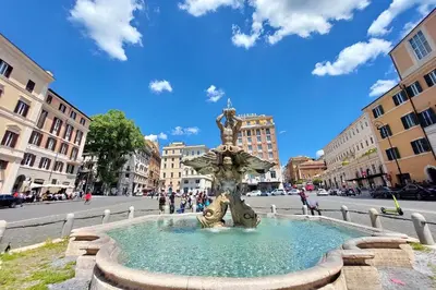a fountain in the middle of a street with a statue at Trevi Feddy's Apartment in Rome