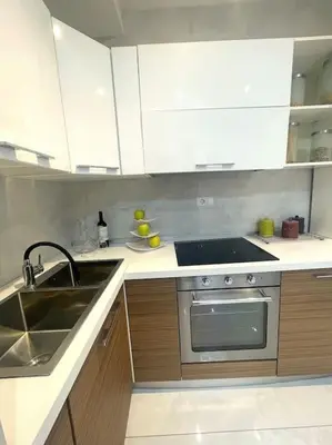 a kitchen with a sink and a stove and cabinets at Tiburtina Luxury Apartment in Rome