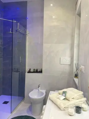 a bathroom with a shower and a toilet and a sink at Tiburtina Luxury Apartment in Rome