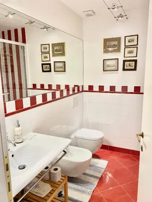 a bathroom with a white toilet and a sink at Quirinale Suite Fontane in Rome
