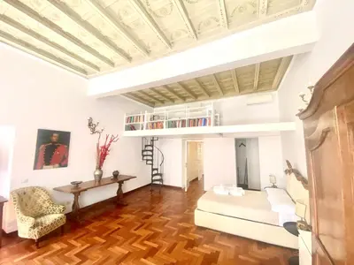 a living room with a white couch and a table at Quirinale Suite Fontane in Rome