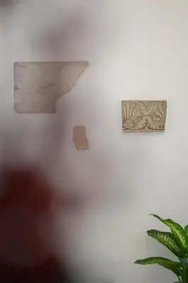 a white wall with two pieces of art on it at Monserrato Charme Apartment - Campo dei Fiori in Rome