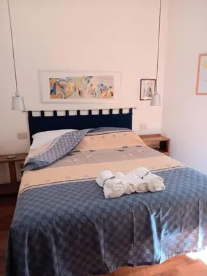 a bed with two rolled up towels on it at la casa del viaggiante in Rome