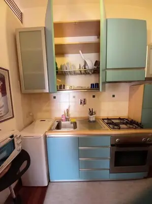 a small kitchen with a sink and a stove at la casa del viaggiante in Rome