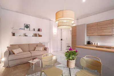 a living room with a couch and a table and chairs at laDolceVita - Flaminio Stylish Flat in Rome
