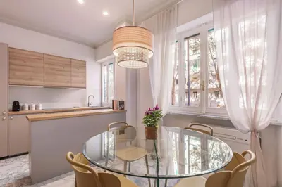 a dining room with a glass table and chairs at laDolceVita - Flaminio Stylish Flat in Rome