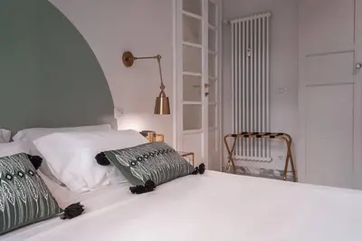 a white bed with two pillows on top of it at laDolceVita - Flaminio Stylish Flat in Rome