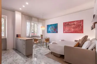 a living room with a bed and a dining room at laDolceVita - Flaminio Stylish Flat in Rome