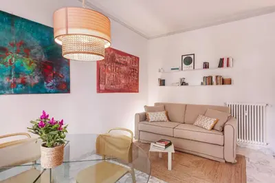 a living room with a couch and a glass table at laDolceVita - Flaminio Stylish Flat in Rome